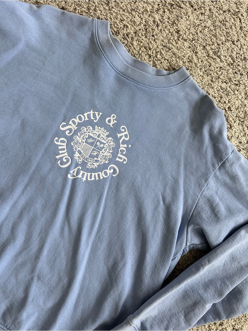 Sporty & Rich Pastel Blue Crewneck Sweatshirt with Crest Logo